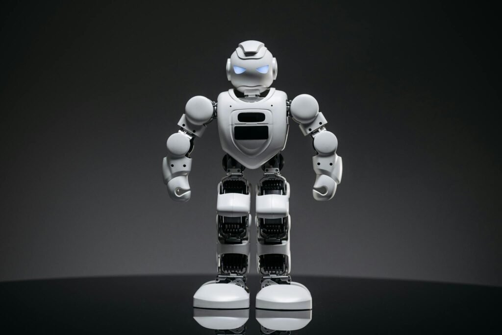 Close-up of a modern white robot with glowing eyes, symbolizing future technology and innovation.